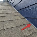 Siding in contact with roof covering materials